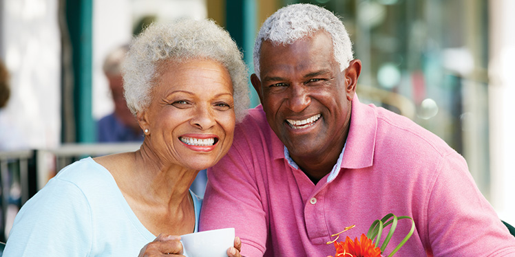 Older couple smiling drinking coffee