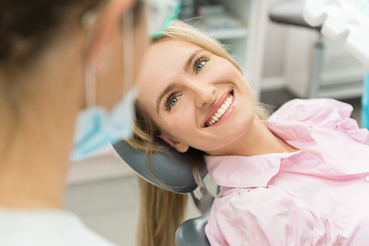 smiling woman sitting in a dental chair