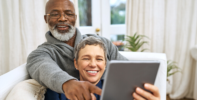 happy couple looking at a computer together