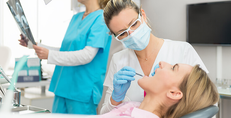 dentist examining a patient's mouth