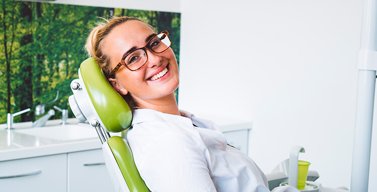 young woman sitting in a dental chair